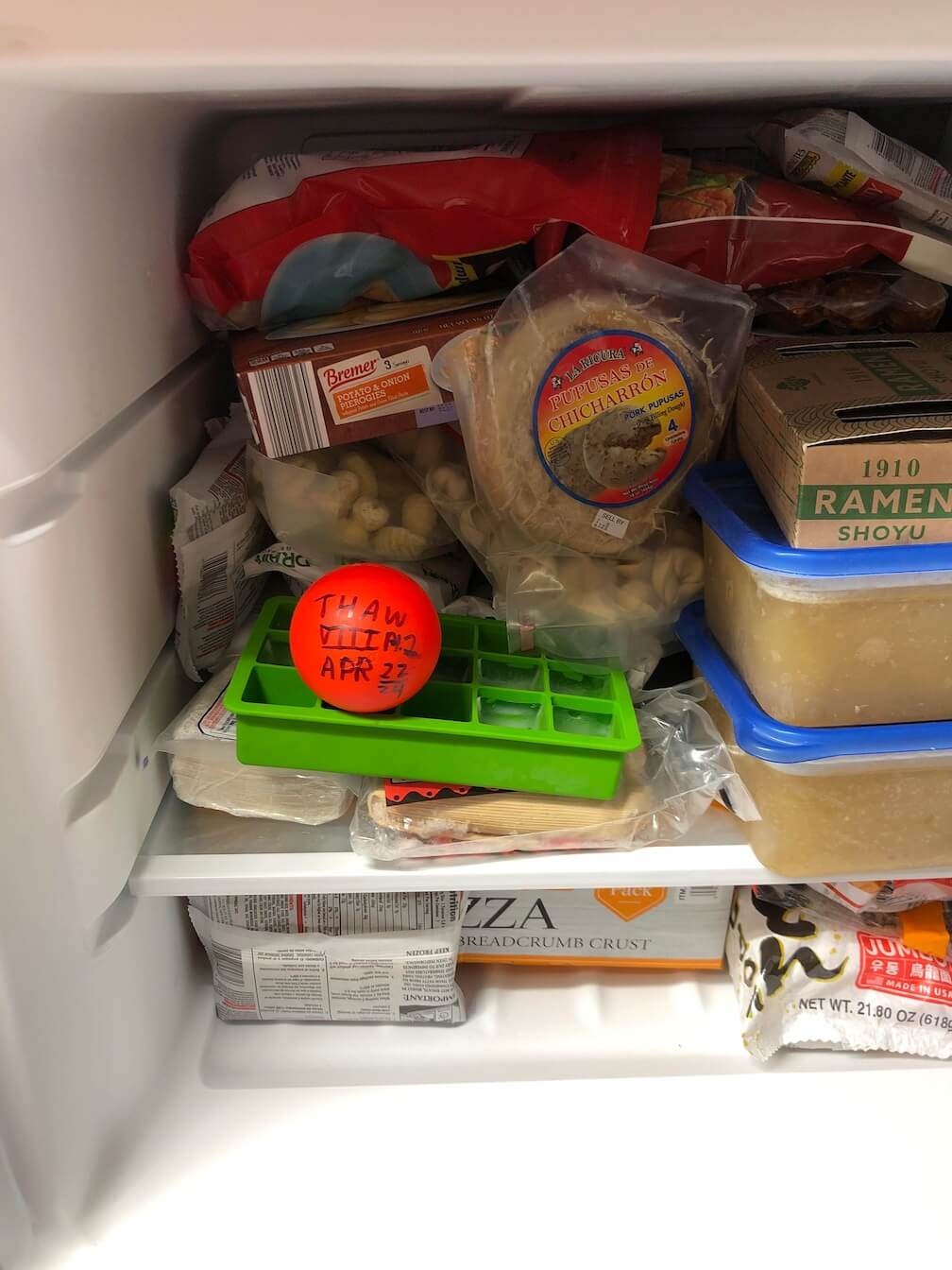 a ball in a freezer with "That VIII Pt 2, April 22-24" written on it