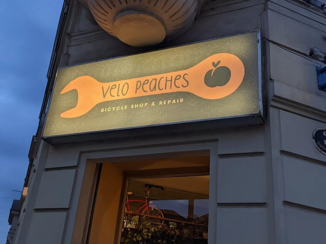 velo peaches bike shop sign outside building